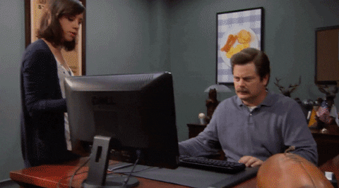 man throwing computer into garbage