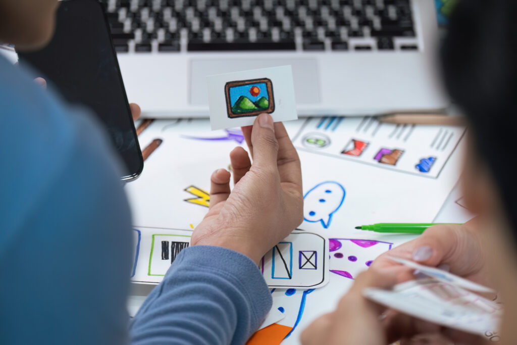 Close up ux developer and ui designer use augmented reality brainstorming about mobile app interface wireframe design on desk at modern office. creative digital development agency.