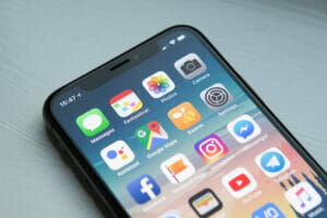 Home screen of an iOS device showing a variety of apps, Photo by William Hook