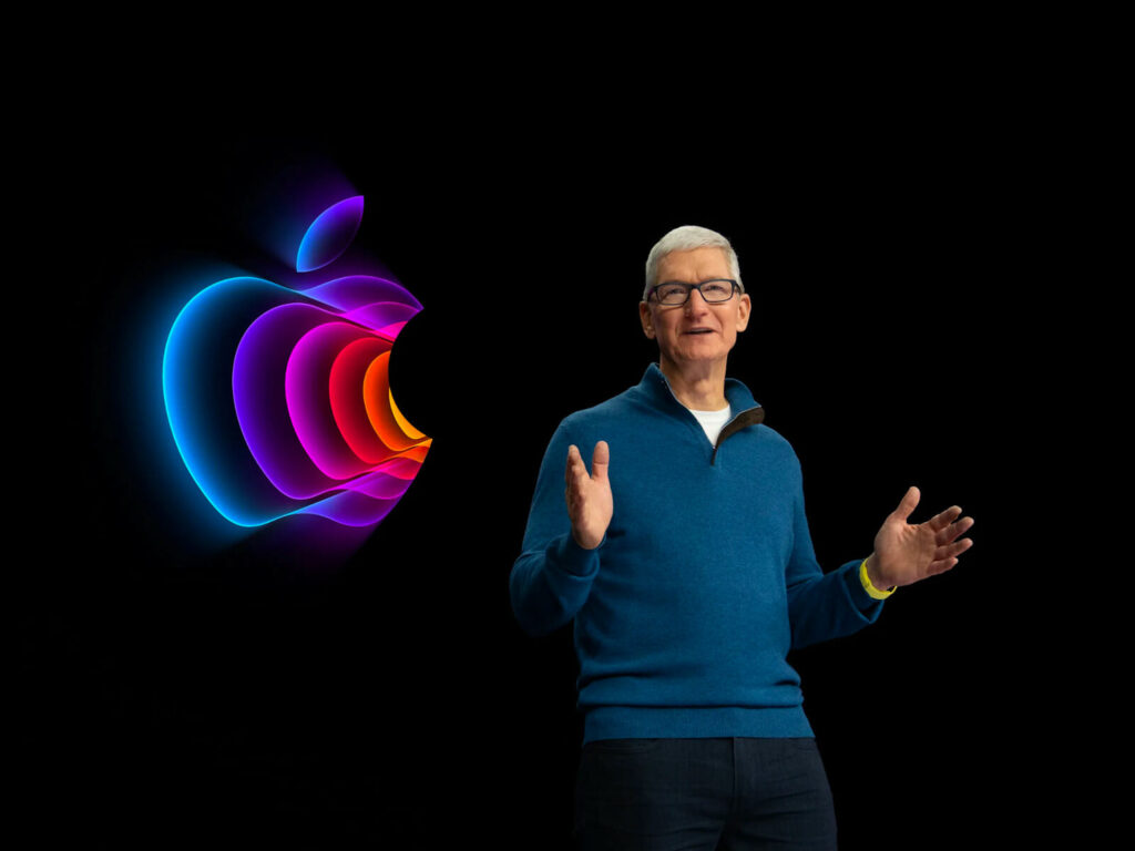 Tim Cook in conference with Apple logo in the back